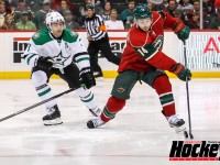 Minnesota's Justin Fontaine shields the puck from Dallas' Stephane Robidas in the Wild's 5-1 win on Oct. 12, 2013 in St. Paul, Minn.