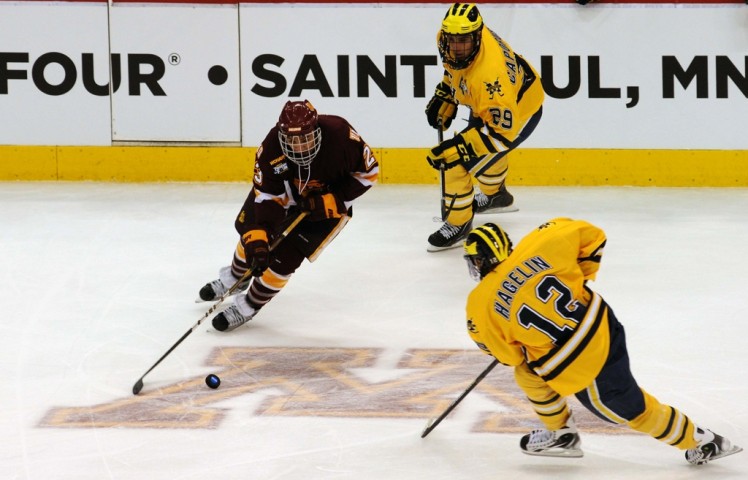 J.T. Brown takes on current New York Rangers forward Carl Hagelin in the 2011 NCAA title game. (Photo by Jordan Doffing)