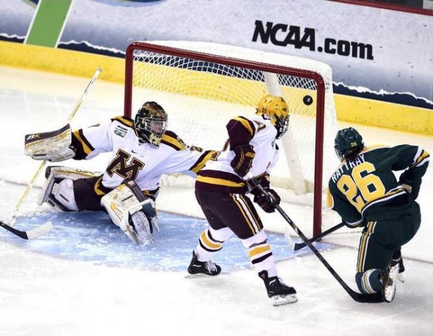 Clarkson University's Jamie Lee Rattray (26) blasts a goal past University of Minnesota goalie Amanda Leveille, left, as Dani Cameranesi (21, center) defends during the 2nd period of the Women's NCAA Ice Hockey Championship held at the TD Bank Sports Center in Hamden, CT. Clarkson defeated Minnesota 5-4 for the school's first national title. (Credit: Sean Elliot | NCAA Photos)